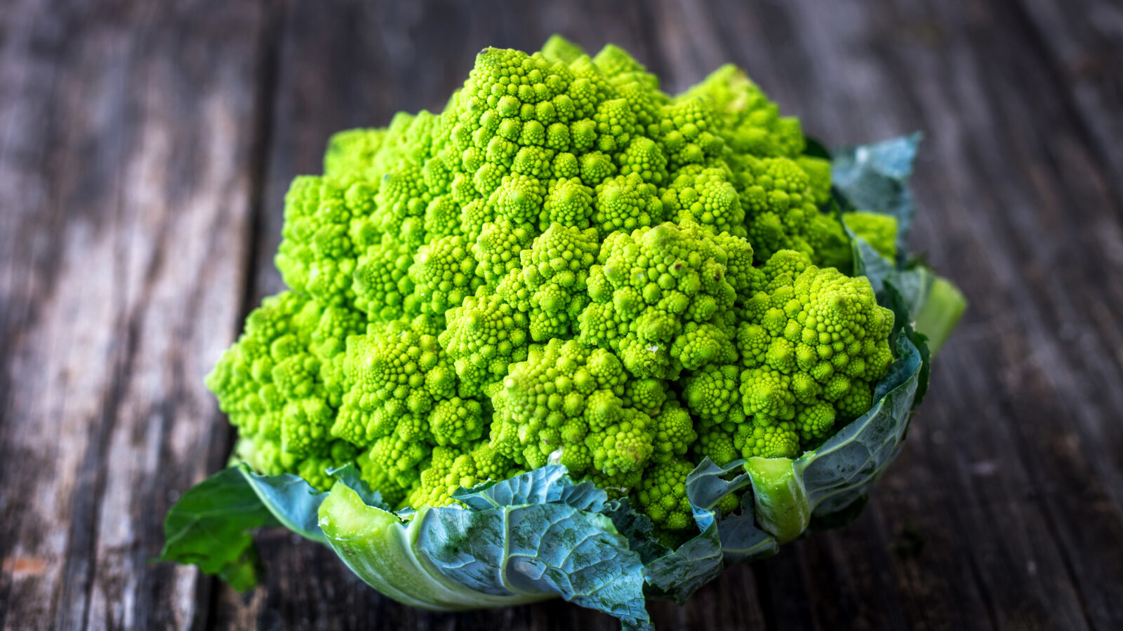 Romanesco cauliflower on wooden background